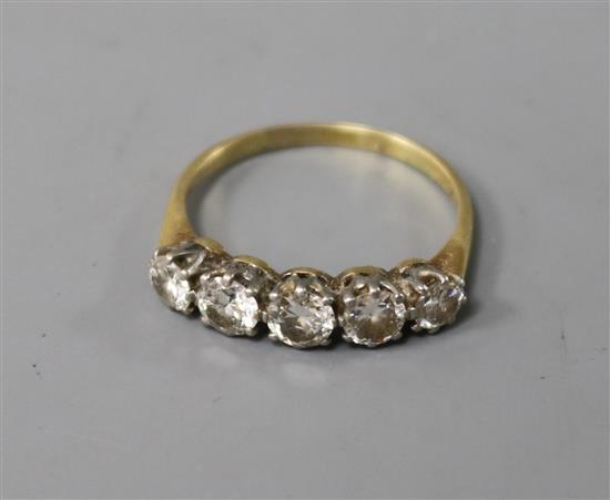 A yellow metal and graduated five stone diamond half hoop ring, size O.